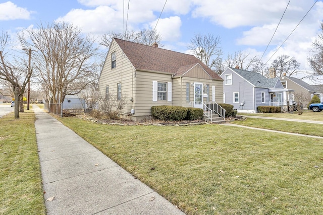 view of front of property featuring entry steps, a shingled roof, a chimney, and a front lawn