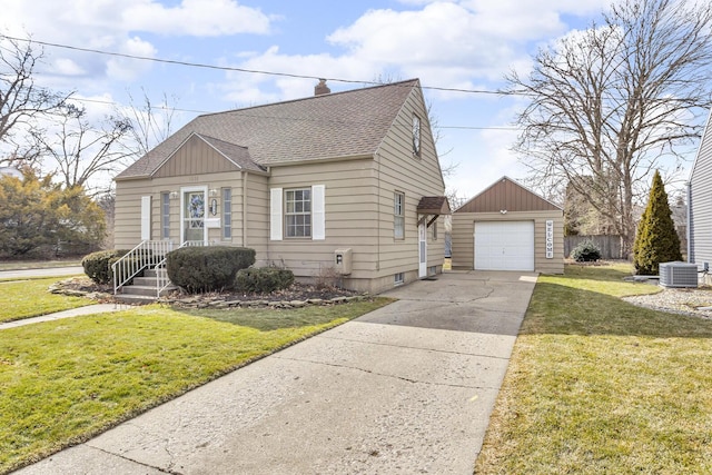 view of front facade with an outbuilding, a detached garage, a shingled roof, concrete driveway, and a front lawn