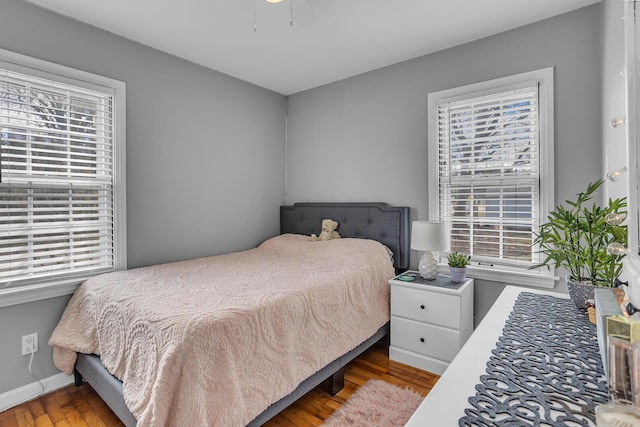 bedroom featuring wood finished floors and baseboards