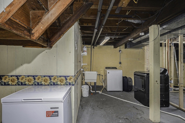 unfinished basement featuring washer and dryer and a sink