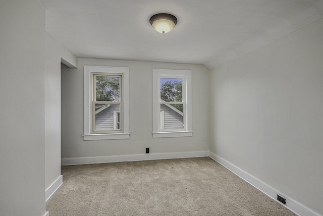 spare room featuring carpet and baseboards