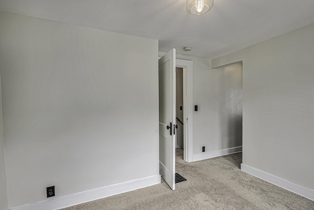 empty room with carpet flooring and baseboards