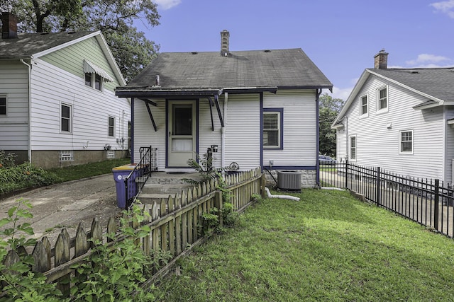 back of property featuring a yard, a porch, and fence private yard