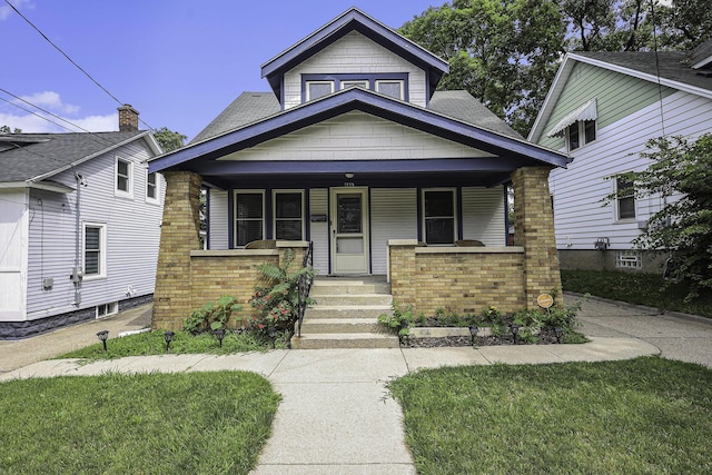 view of front of property featuring a porch and brick siding