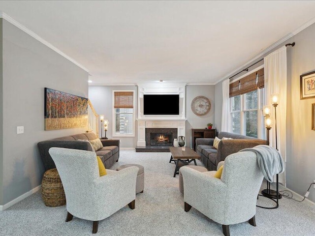 living area featuring carpet floors, a warm lit fireplace, baseboards, and ornamental molding