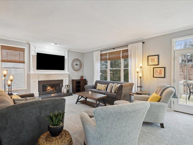 living room featuring ornamental molding, light colored carpet, and a lit fireplace