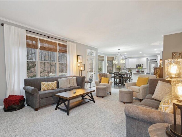 living area featuring light carpet and crown molding