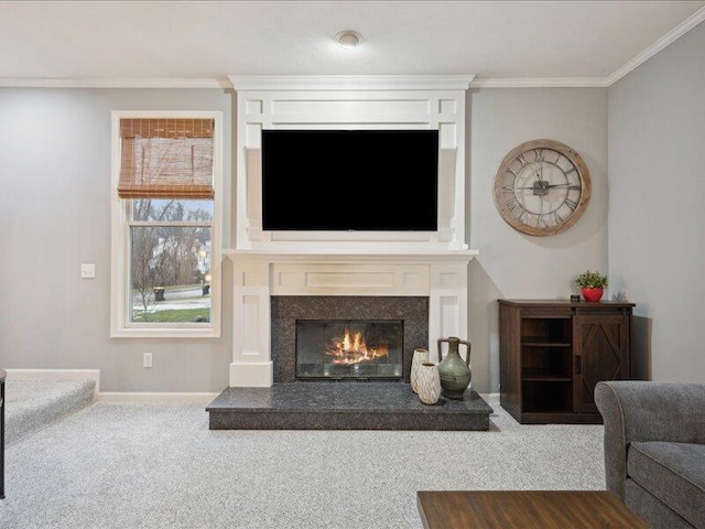 carpeted living area featuring baseboards, crown molding, and a glass covered fireplace