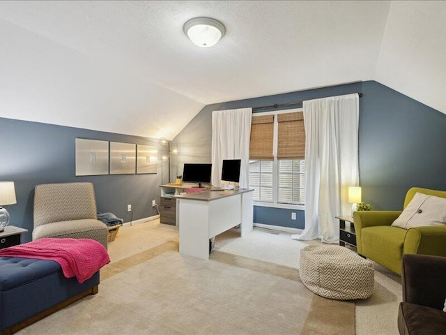 carpeted home office with lofted ceiling and baseboards