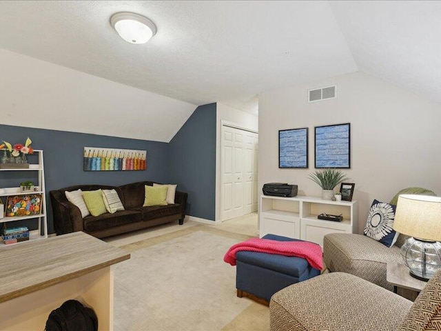 living area featuring visible vents and vaulted ceiling