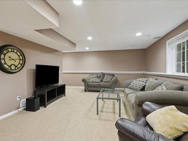 carpeted living area with recessed lighting and baseboards