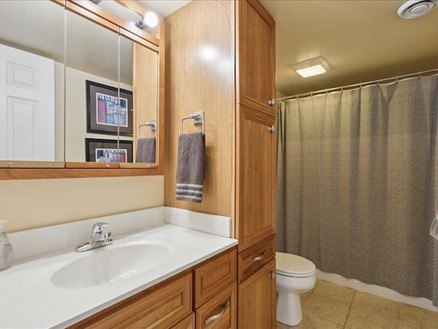 bathroom featuring toilet, tile patterned flooring, a shower with shower curtain, and vanity