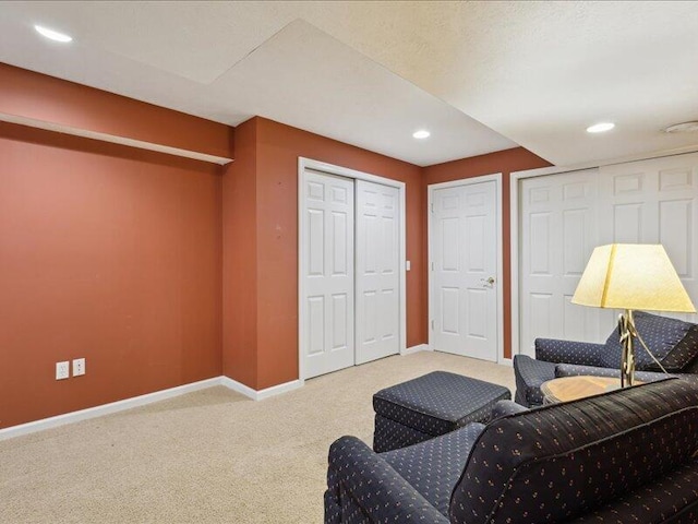 living room featuring carpet, baseboards, and recessed lighting