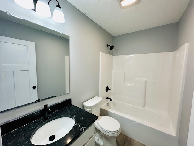 2653 Mclaughlin Ave, Muskegon, MI 49442 - full bathroom featuring a textured ceiling, wood finished floors, vanity, toilet, and shower / bathtub combination