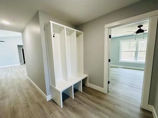2653 Mclaughlin Ave, Muskegon, MI 49442 - mudroom featuring baseboards, ceiling fan, and wood finished floors