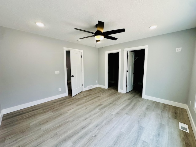 2653 Mclaughlin Ave, Muskegon, MI 49442 - unfurnished bedroom featuring a textured ceiling, baseboards, visible vents, and wood finished floors