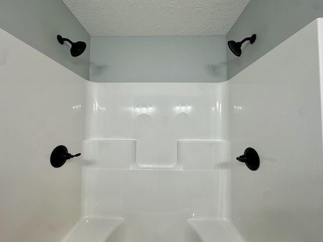 2653 Mclaughlin Ave, Muskegon, MI 49442 - bathroom with a textured ceiling and walk in shower