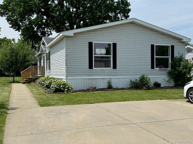 11426 Harbor Cv, Fenton, MI 48430 - view of property exterior featuring a lawn