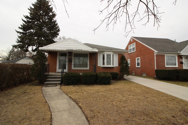 bungalow featuring brick siding, a porch, and a front yard