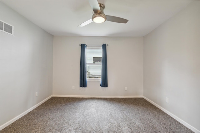 carpeted empty room with a ceiling fan, visible vents, and baseboards