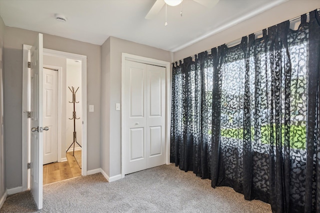 bedroom featuring a closet, carpet flooring, a ceiling fan, and baseboards