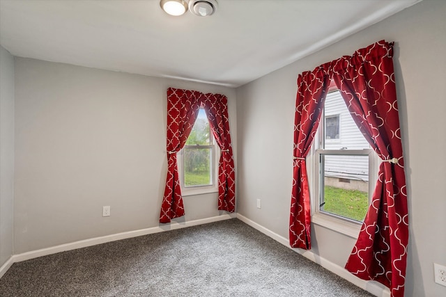 empty room with baseboards, carpet, and a healthy amount of sunlight