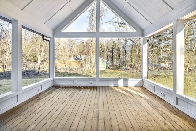 unfurnished sunroom featuring lofted ceiling and plenty of natural light