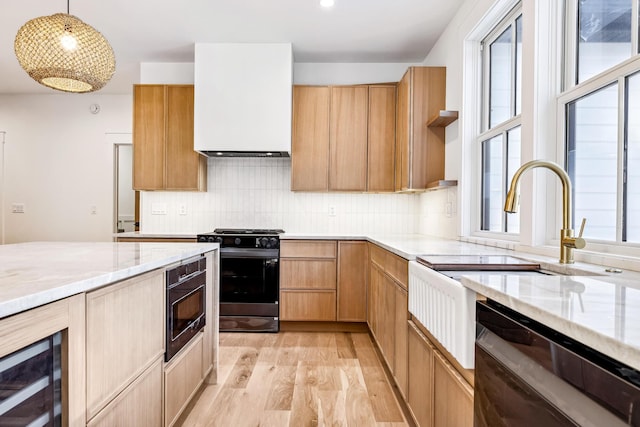 kitchen featuring wine cooler, light stone counters, light wood-style flooring, stainless steel dishwasher, and black range with gas stovetop