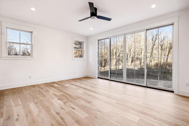 spare room with recessed lighting, light wood-type flooring, visible vents, and baseboards