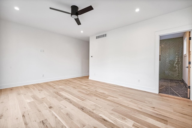 empty room with light wood-type flooring, ceiling fan, visible vents, and recessed lighting