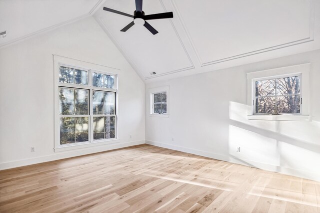 unfurnished room with lofted ceiling, light wood-style flooring, baseboards, and a ceiling fan