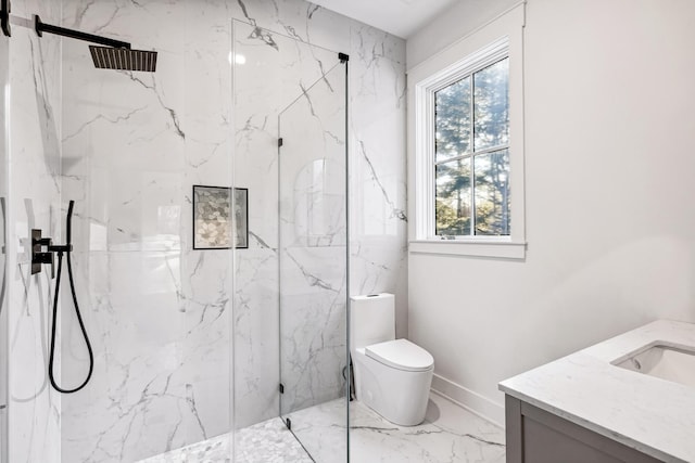 bathroom featuring marble finish floor, toilet, vanity, and a marble finish shower