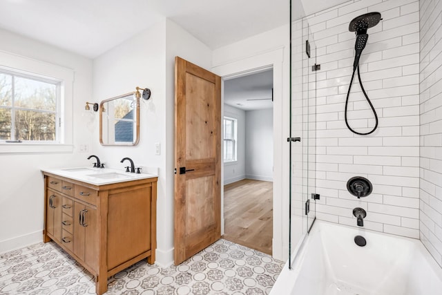 bathroom with shower / bath combination, tile patterned floors, baseboards, and vanity