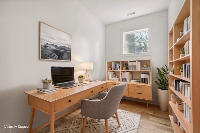 home office featuring light wood-style floors and visible vents