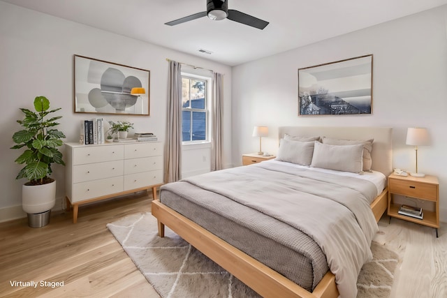 bedroom with ceiling fan, baseboards, visible vents, and light wood-style floors