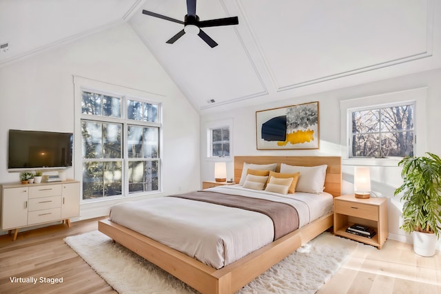 bedroom with light wood finished floors, high vaulted ceiling, and a ceiling fan