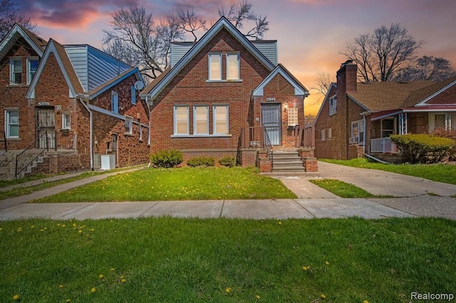 view of front facade featuring a front yard and brick siding