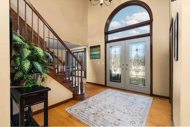 entryway featuring french doors, hardwood / wood-style flooring, and a wealth of natural light