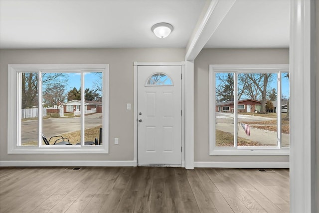 entrance foyer featuring wood finished floors, visible vents, and baseboards