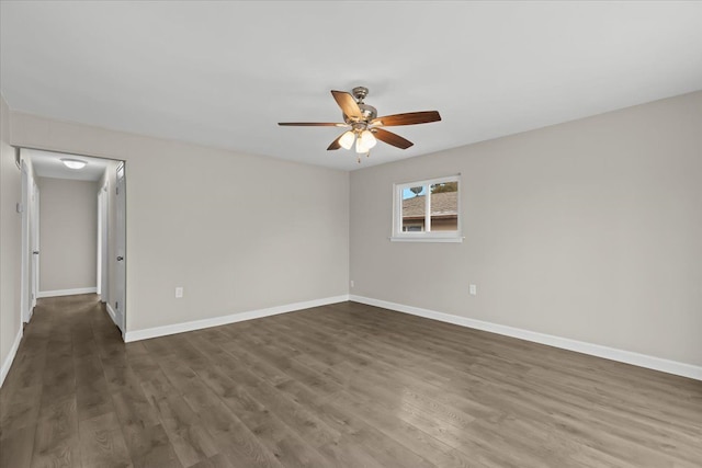 unfurnished room featuring ceiling fan, baseboards, and wood finished floors