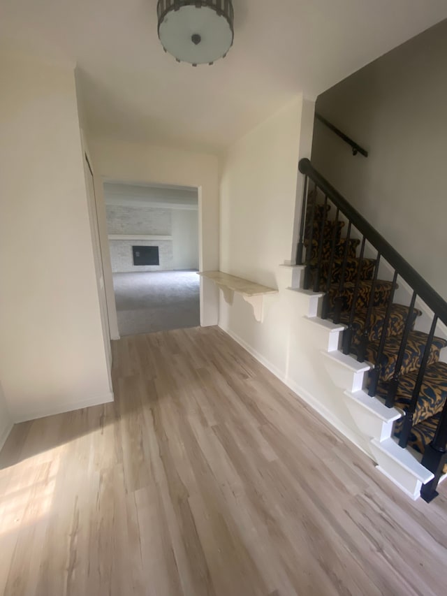 interior space featuring stairs, baseboards, and wood finished floors