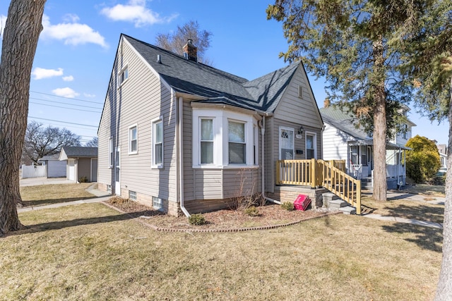 view of front of property with a chimney, a front lawn, and roof with shingles