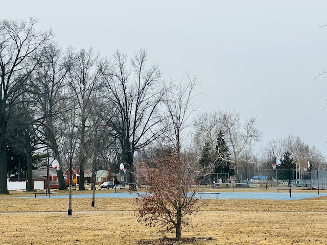 view of community featuring community basketball court and fence