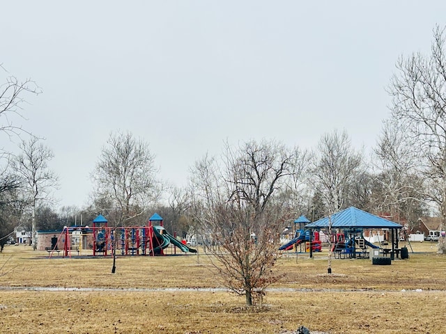 community jungle gym featuring a lawn