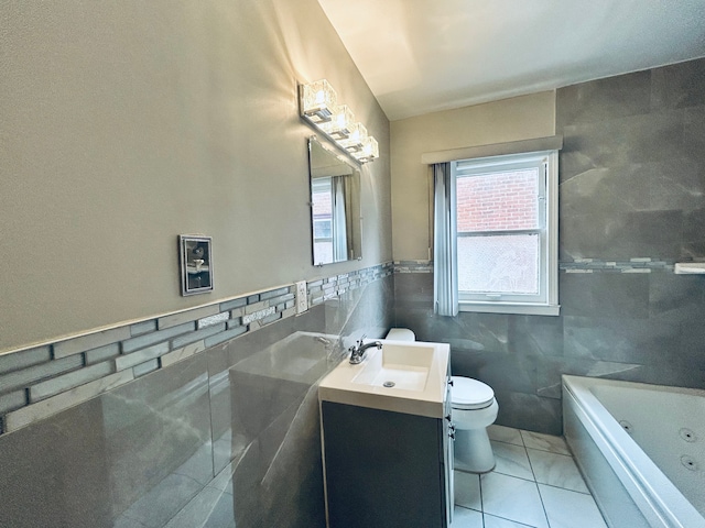 full bathroom featuring tile walls, toilet, a bathing tub, vanity, and tile patterned flooring