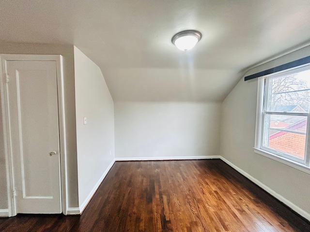 bonus room with lofted ceiling, wood finished floors, and baseboards