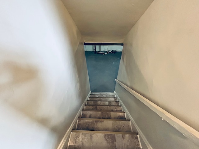 stairway featuring concrete flooring