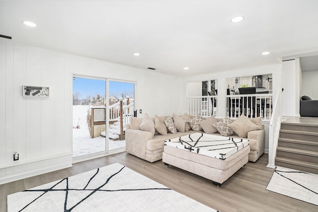 living room with recessed lighting, wood finished floors, visible vents, and stairs