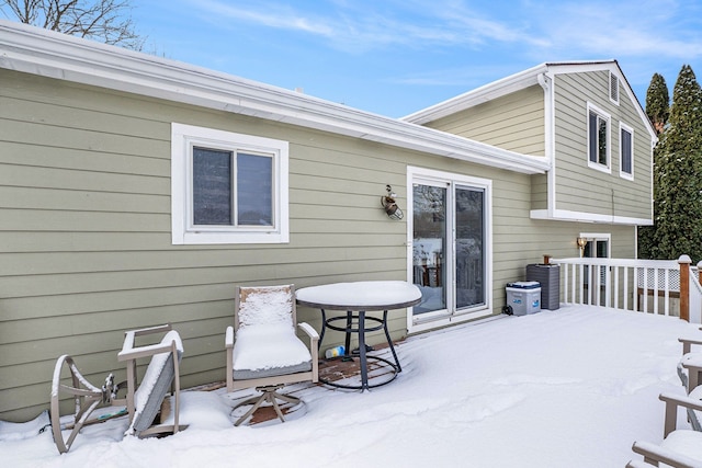 snow covered property featuring a patio