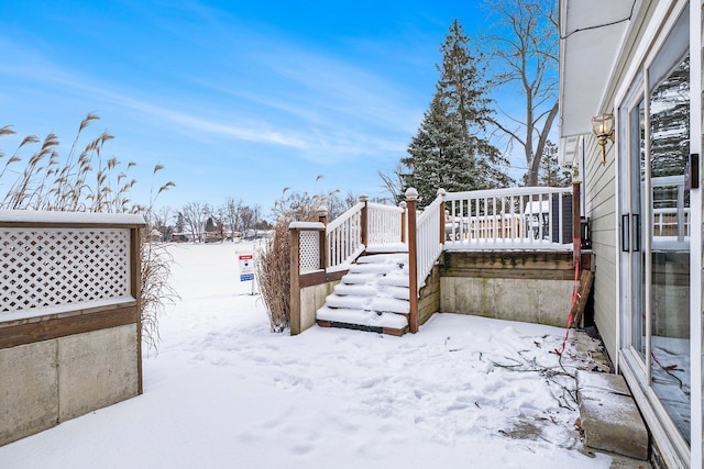 snowy yard with a wooden deck